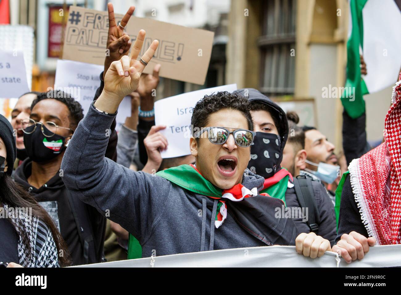 Bristol, UK. 15th May, 2021. Pro-Palestinian supporters carrying placards and waving Palestinian flags are pictured as they march through Bristol in a protest march to show their solidarity with the Palestinian people. The protest march and rally was held to allow people to show their support and solidarity with the Palestinian people after 73 Years of Nakba and to protest about Israel's recent actions in Gaza. Credit: Lynchpics/Alamy Live News Stock Photo