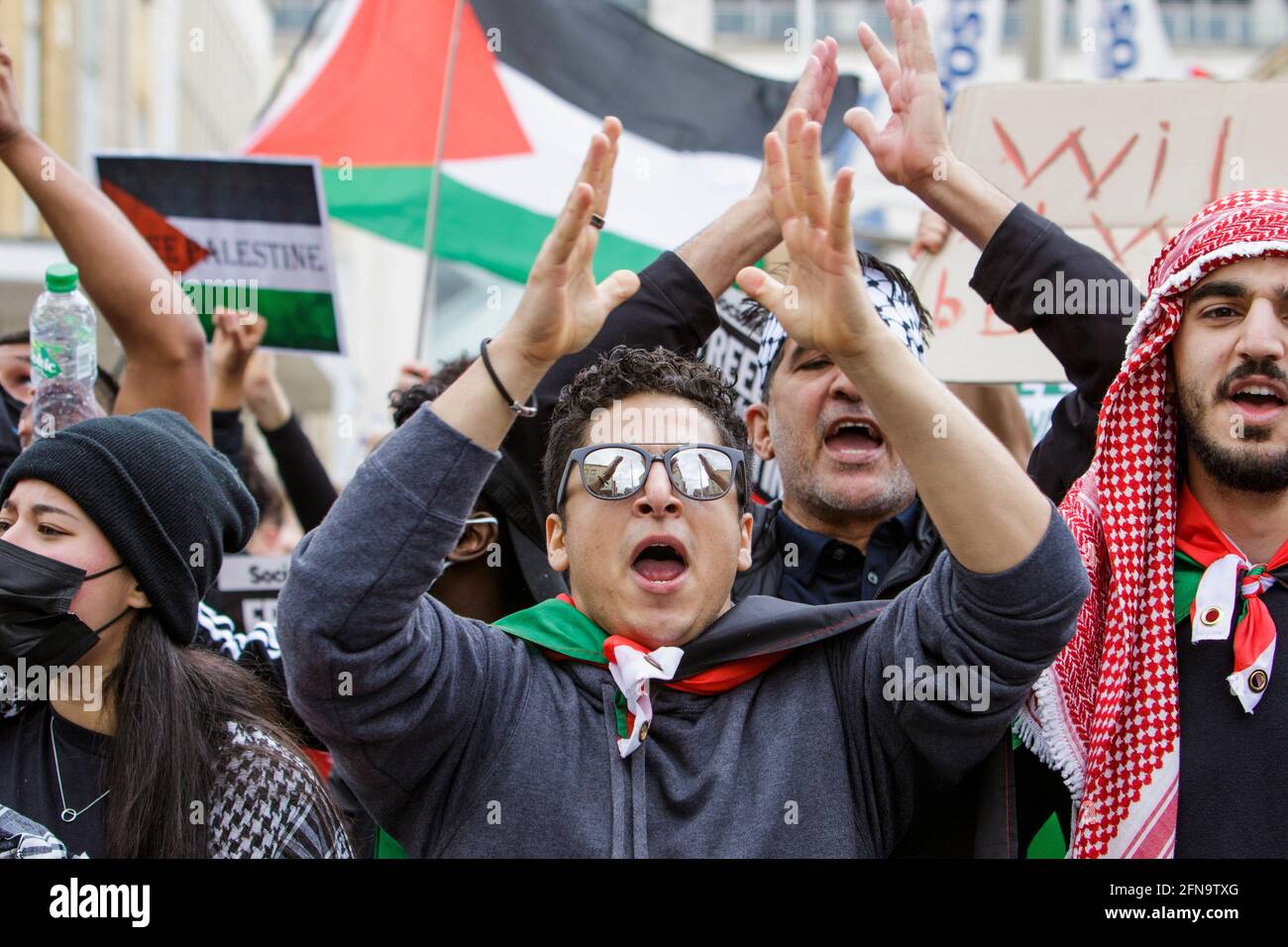 Bristol, UK. 15th May, 2021. Pro-Palestinian demonstrators waving Palestinian flags are pictured as they march through Bristol in a protest march to show their solidarity with the Palestinian people. The protest march and rally was held to allow people to show their support and solidarity with the Palestinian people after 73 Years of Nakba and to protest about Israel's recent actions in Gaza. Credit: Lynchpics/Alamy Live News Stock Photo