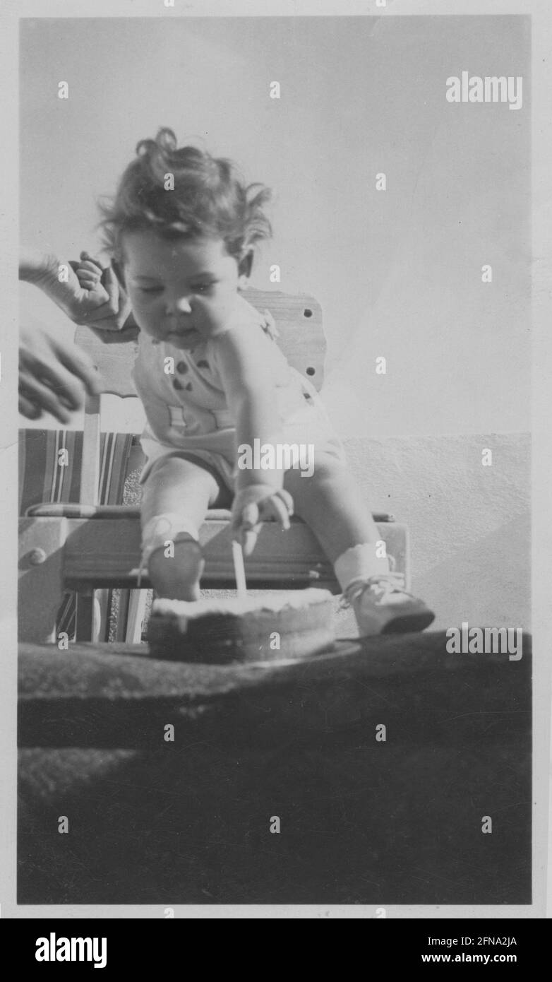 Baby girl's first birthday cake and candle 1939 black and white stock photo Stock Photo