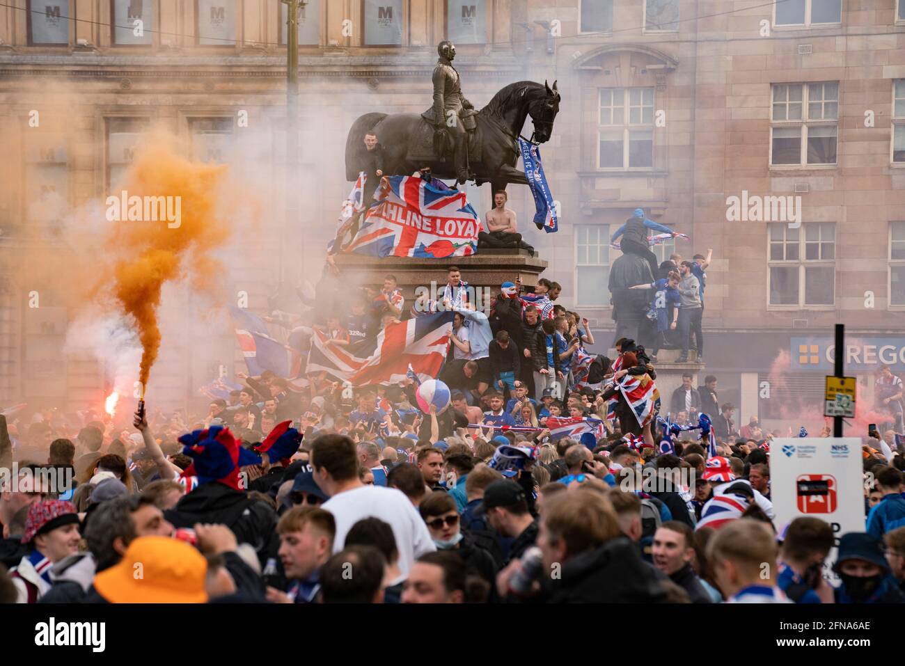 Glasgow, Scotland, UK. 15 May 2021. Thousands of supporters and fans of Rangers football club descend into George Square in Glasgow to celebrate winning the Scottish Premiership championship for the 55th time and the first time for 10 years.Iain Masterton/Alamy Live News Stock Photo
