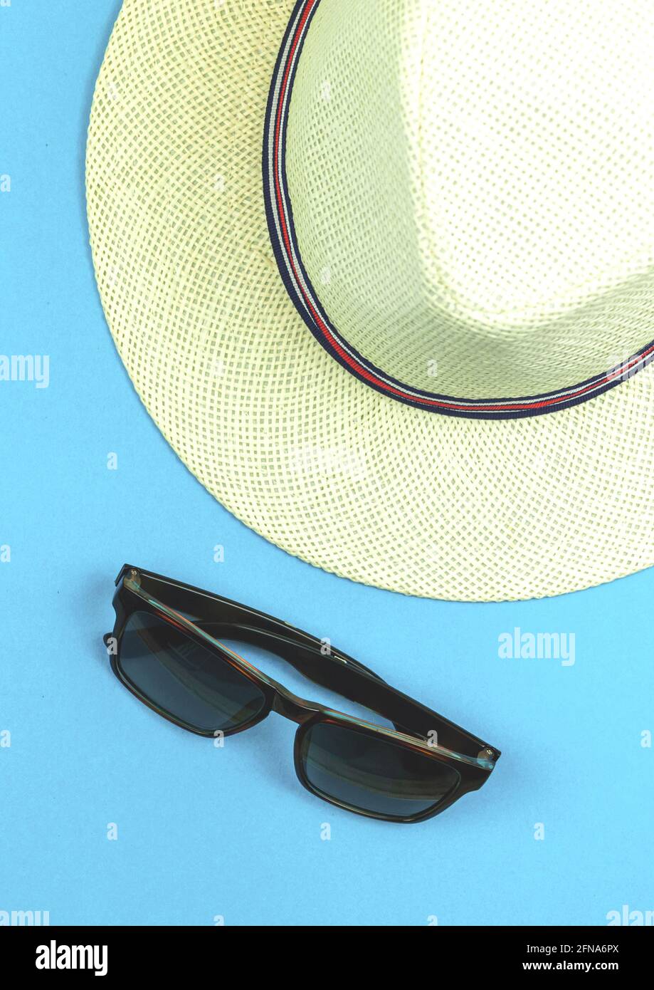 Summer blue background with straw tropical hat and sunglasses for a ...