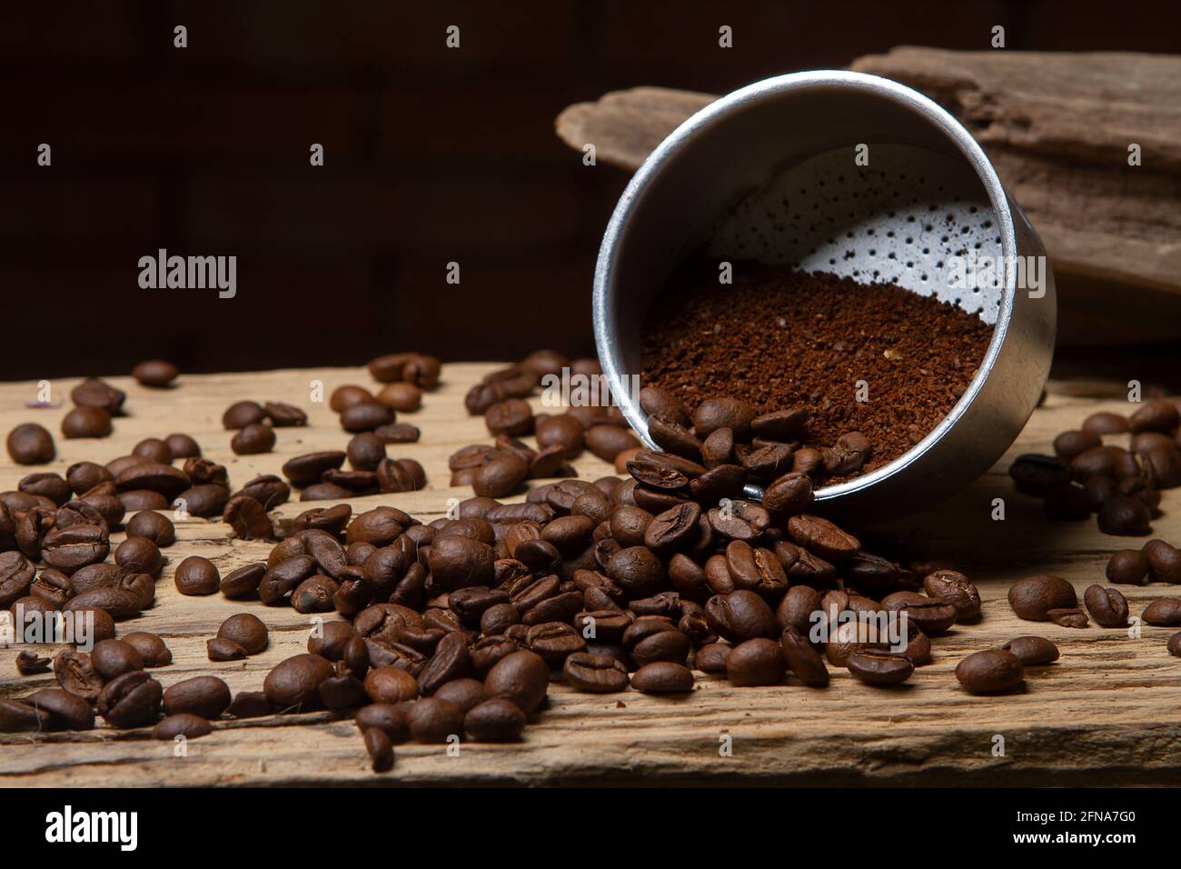 https://c8.alamy.com/comp/2FNA7G0/mocha-coffee-filter-with-ground-coffee-and-some-scattered-coffee-beans-2FNA7G0.jpg