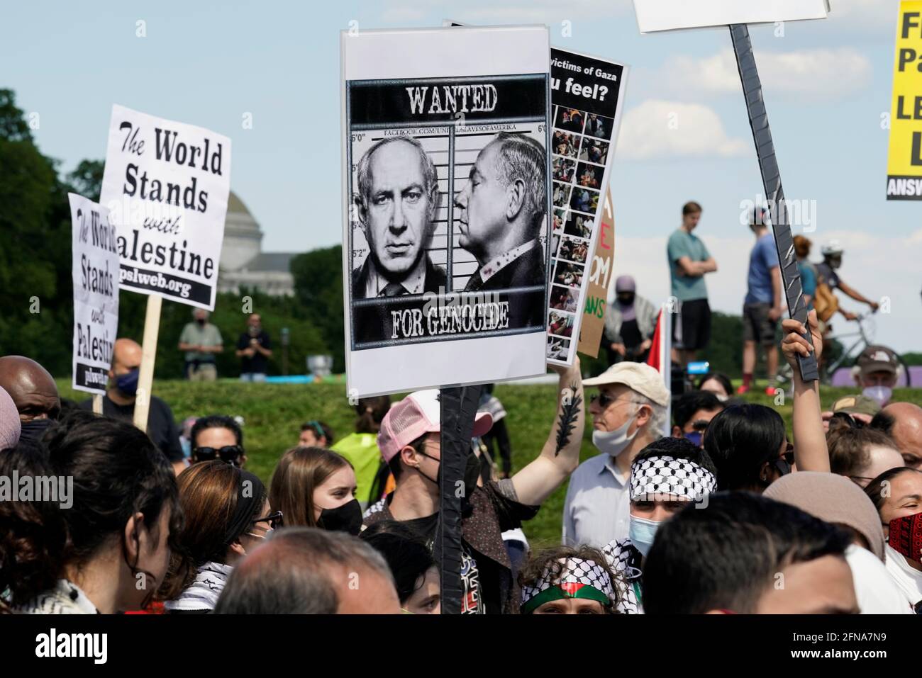 A pro-Palestinian demonstrator holds a placard with a photography of Israeli Prime Minister Benjamin Netanyahu during a protest against the ongoing conflict in Israel and Palestinian territories during a rally at the Washington Monument in Washington, U.S., May 15, 2021. REUTERS/Yuri Gripas Stock Photo