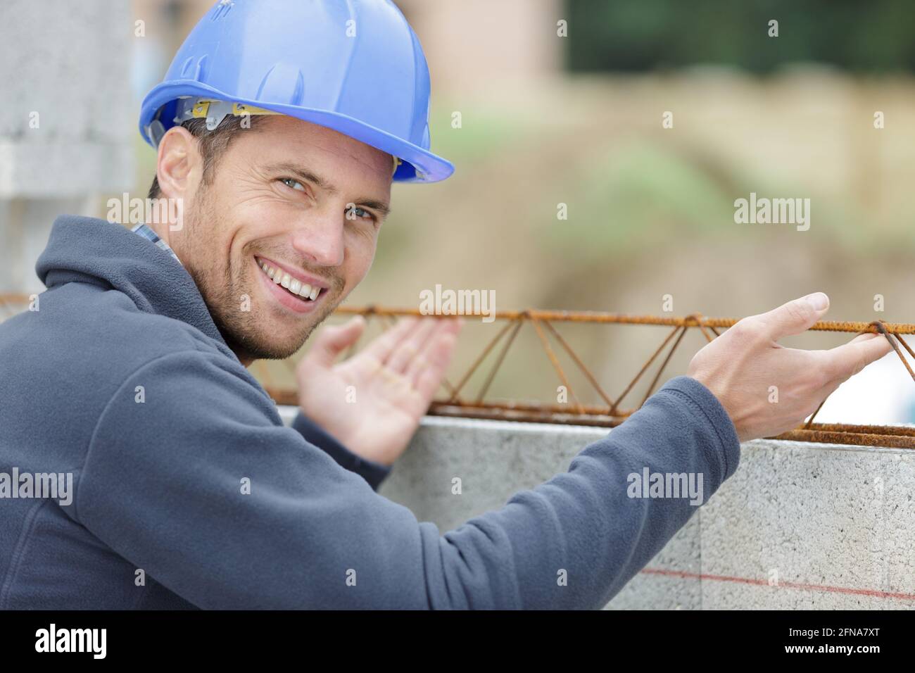 Man With Building happy man next to building construction reinforced concrete structure ...
