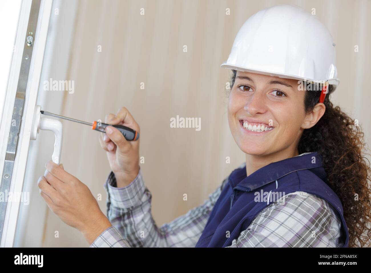 woman installing door handle using screwdriver Stock Photo Alamy