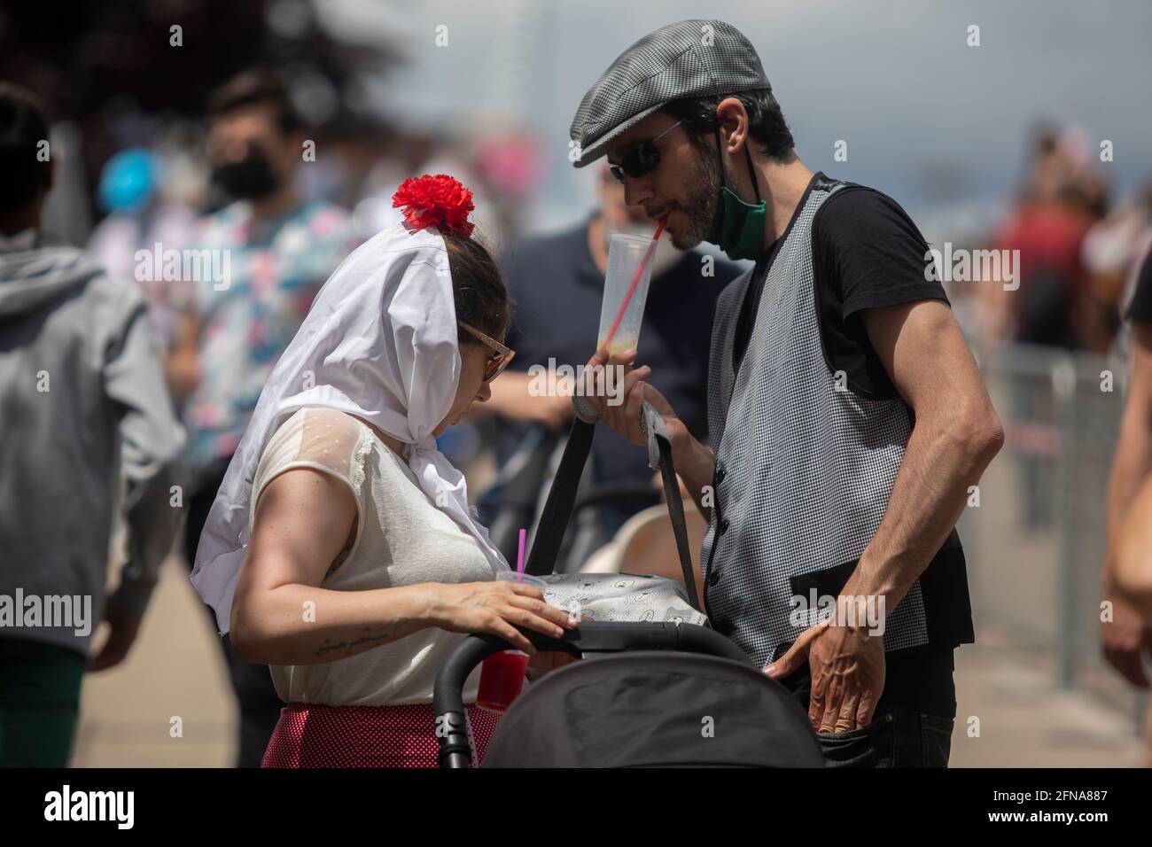 Madrid, Spain. 15th May, 2021. A couple dressed as chulapos seen during the San Isidro festivity in the IFEMA fairground.One of the most celebrated holidays of Madrid is the Feast Day of San Isidro which this year took place in the IFEMA fairground. Credit: SOPA Images Limited/Alamy Live News Stock Photo