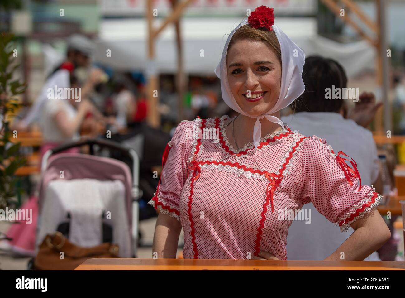 Madrid, Spain. 15th May, 2021. A woman dressed as a chulapa, poses for photos, during the San Isidro festivity in the IFEMA fairground.One of the most celebrated holidays of Madrid is the Feast Day of San Isidro which this year took place in the IFEMA fairground. Credit: SOPA Images Limited/Alamy Live News Stock Photo