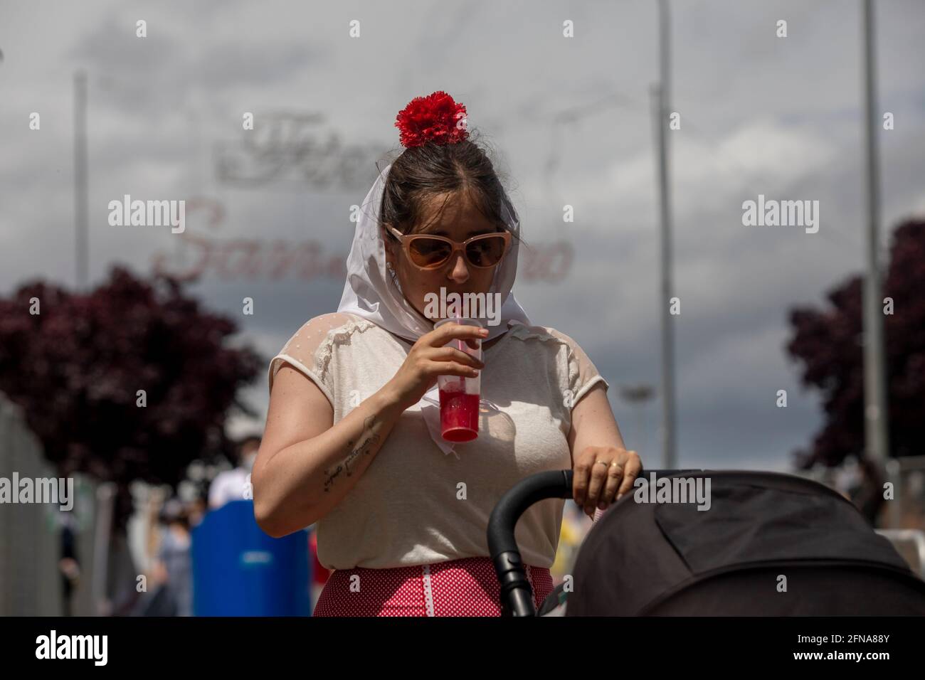 Madrid, Spain. 15th May, 2021. A woman dressed as a chulapa seen during the San Isidro festivity in the IFEMA fairground.One of the most celebrated holidays of Madrid is the Feast Day of San Isidro which this year took place in the IFEMA fairground. Credit: SOPA Images Limited/Alamy Live News Stock Photo