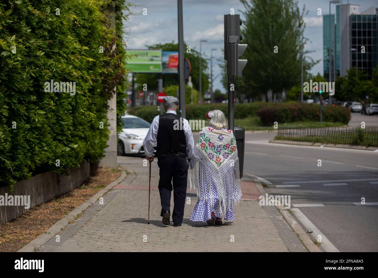 Madrid, Spain. 15th May, 2021. An elderly couple dressed as chulapos are seen during the San Isidro festivity in the IFEMA fairground.One of the most celebrated holidays of Madrid is the Feast Day of San Isidro which this year took place in the IFEMA fairground. Credit: SOPA Images Limited/Alamy Live News Stock Photo