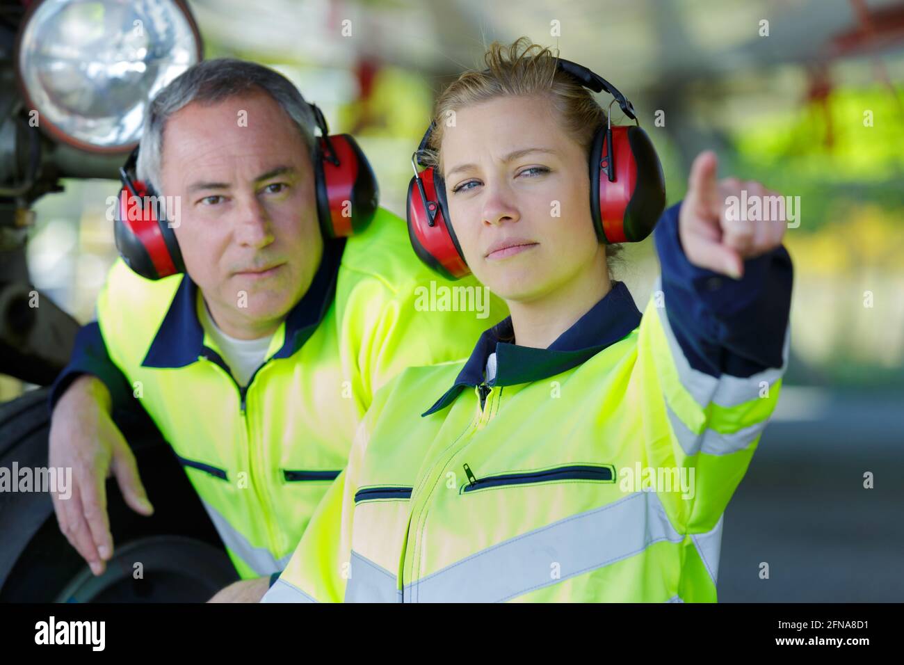 airport staff looking at aircraft Stock Photo - Alamy
