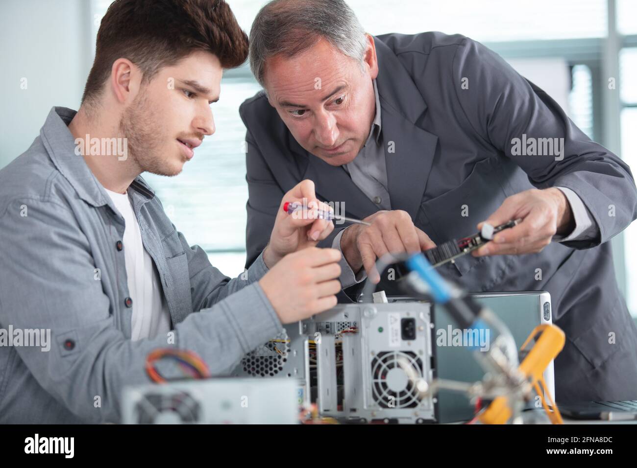 apprentice repairing computer in technical school Stock Photo - Alamy