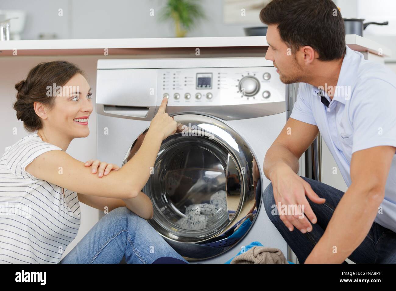couple checking a washing machine Stock Photo Alamy