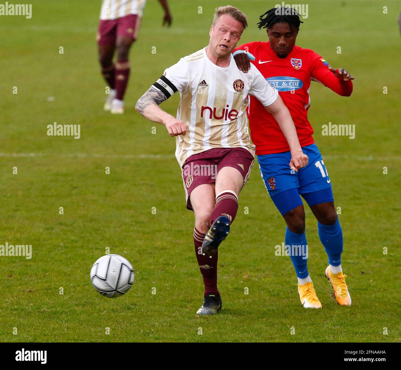 Dagenham, UK. 15th May, 2021. DAGENHAM ENGLAND - MAY 15: L-R Nathan Clarke of FC Halifax Town holds of Dagenham & Redbridge's Darren McQueen during Vanarama National League match between Dagenham and Redbridge and Halifax Town, at The Chigwell Construction Stadium on May 15, 2021 in Dagenham, England Credit: Action Foto Sport/Alamy Live News Stock Photo