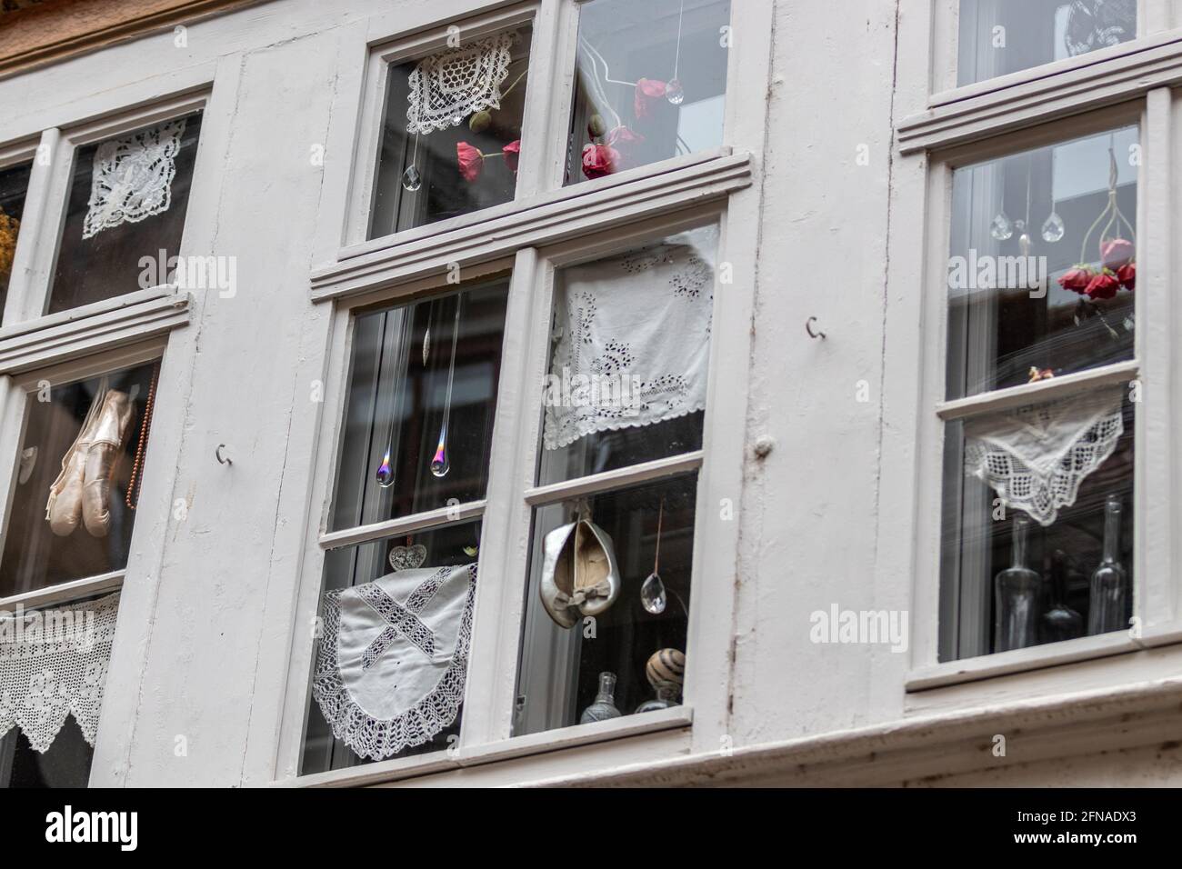 Window decorations with shoes and doilies on a house in Erfurt, thuringia Stock Photo