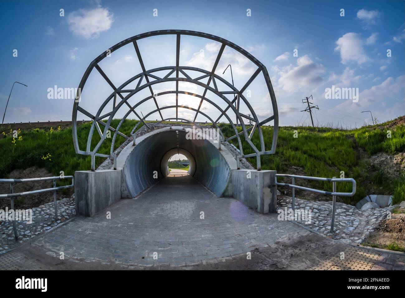 round tunnel footpath on blue sky background Stock Photo