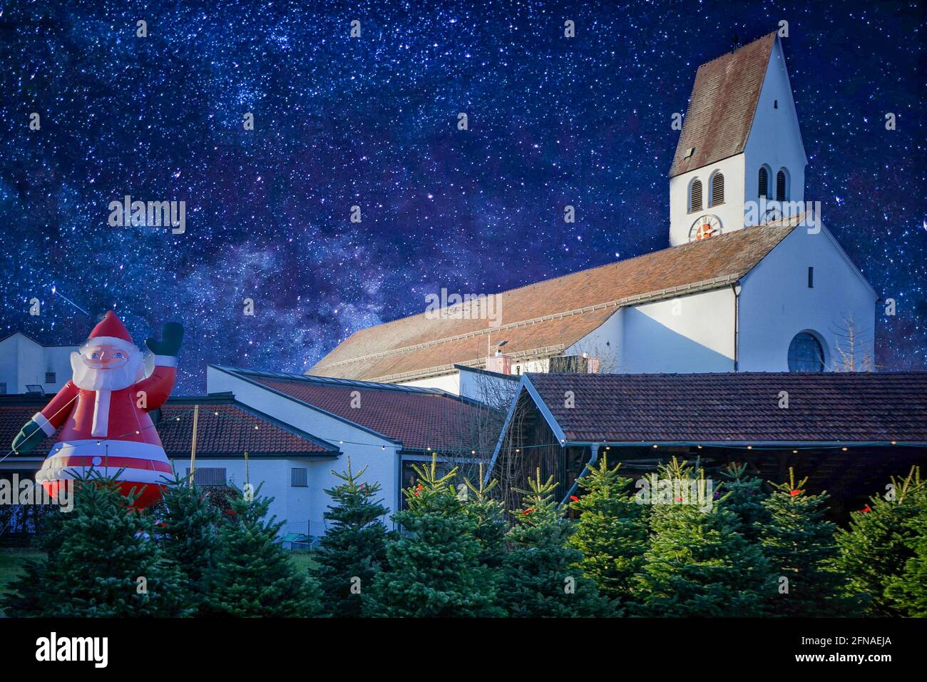 Christmas tree sales stand on a street in front of a church. In the