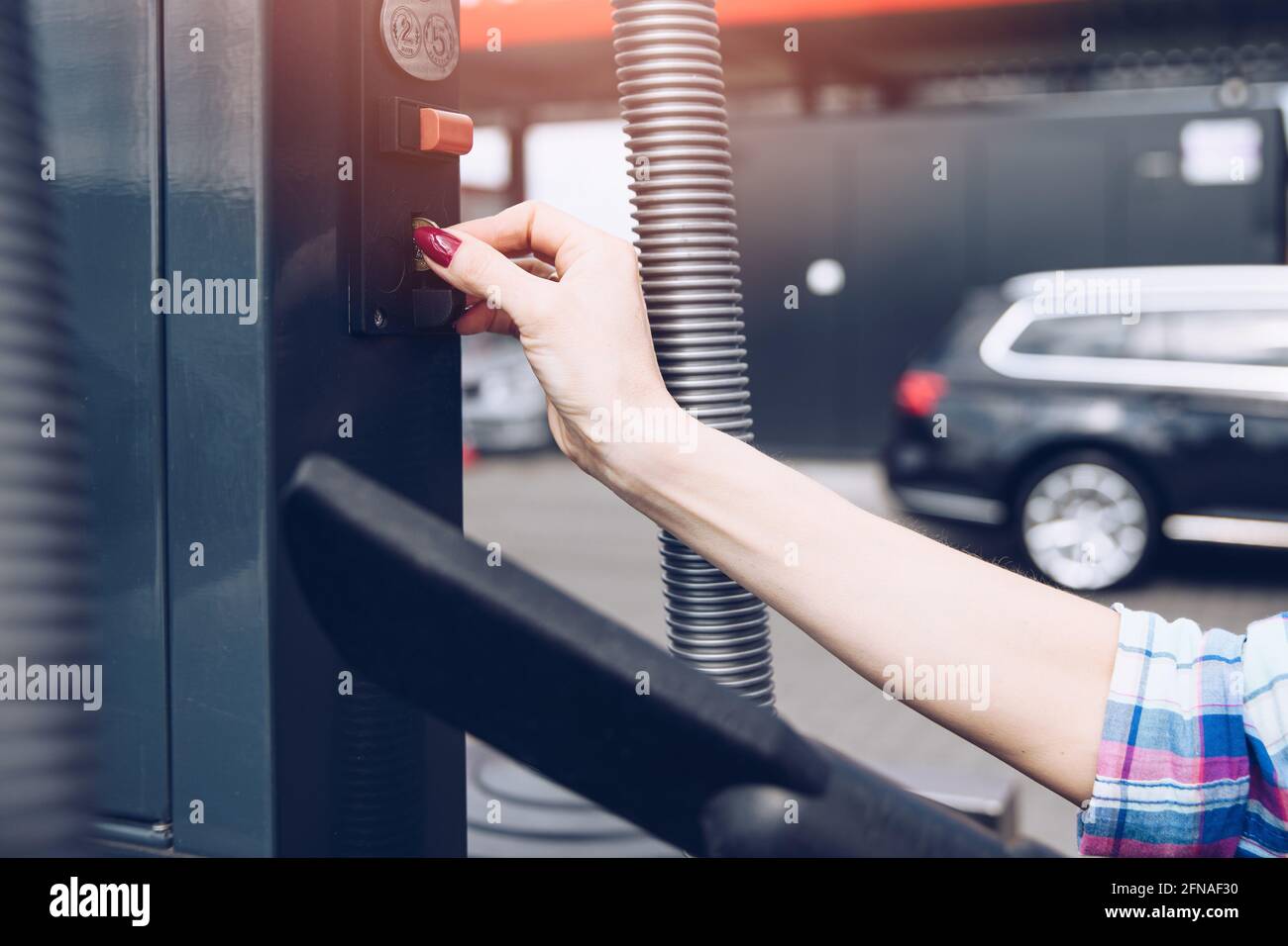 Person using self service automatic car wash vacuum machine Stock Photo ...