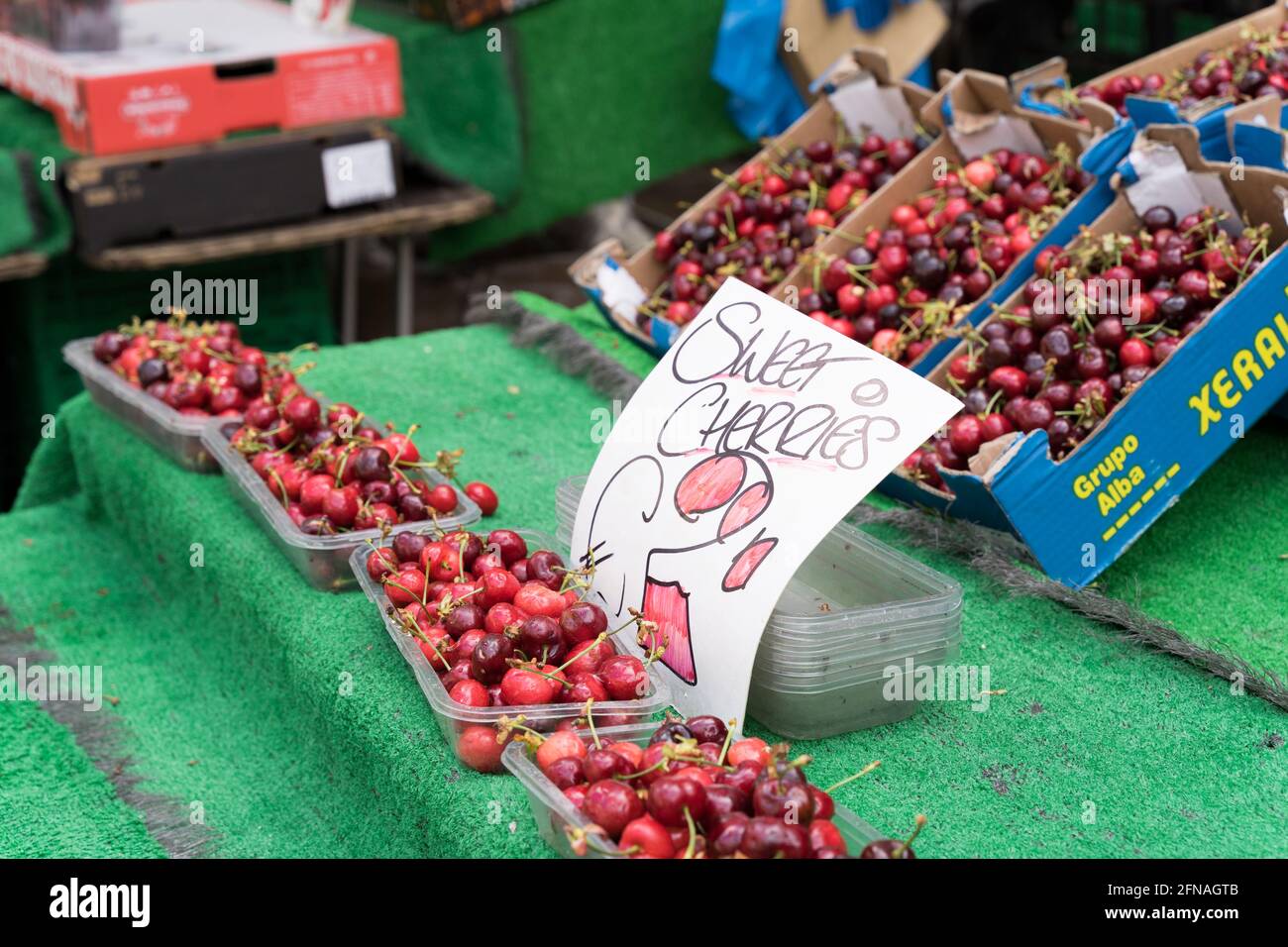 Sweet cherries in plastic box on display for sale in Fruit stall in Bromley , Kent, Great Britain Stock Photo
