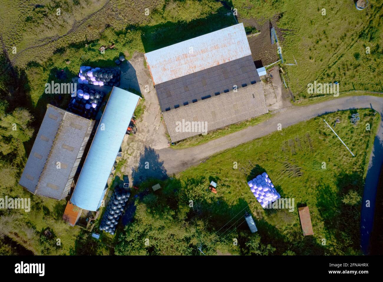 Farm and farmyard buildings in rural countryside aerial view from above Stock Photo