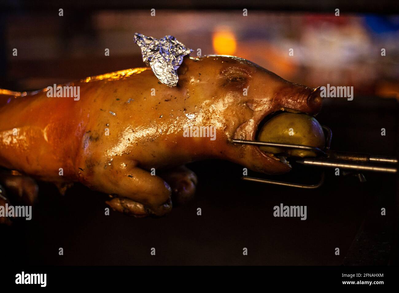 The whole pig is roasted on fire. Golden crust on a toast fried over an