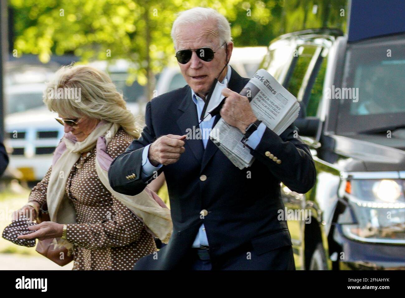 U.S. President Joe Biden removes his face mask while walking with first lady Jill Biden as they depart the White House en route to Wilmington, Delaware from the Ellipse in Washington, U.S., May 15, 2021. REUTERS/Yuri Gripas Stock Photo