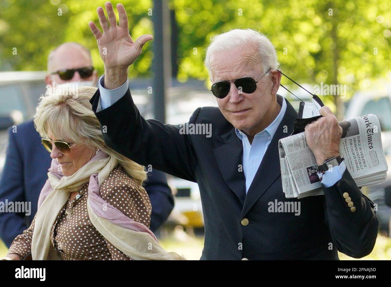 U.S. President Joe Biden waves as he removing his face mask while walking with first lady Jill Biden as they depart from the White House en route to Wilmington, Delaware from the Ellipse in Washington, U.S., May 15, 2021. REUTERS/Yuri Gripas Stock Photo