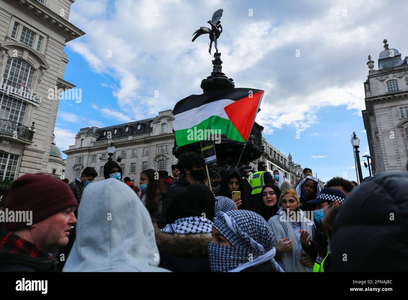 London UK. 15 May 2021. Flag of Palestine against the backdrop of the Eros on Piccadilly Circus during the March for Palestine. Credit Waldemar Sikora Stock Photo