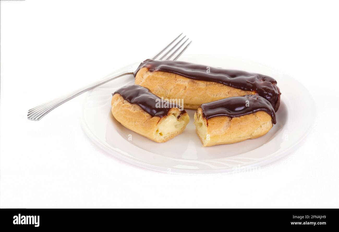 Two Chocolate Eclairs on a White Plate with a Fork Stock Photo