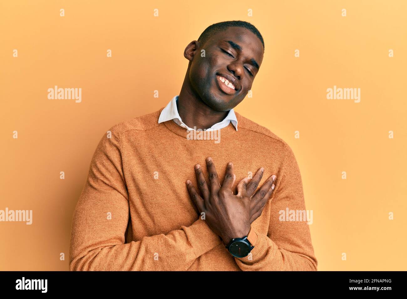 Young african american man wearing casual clothes smiling with hands on ...