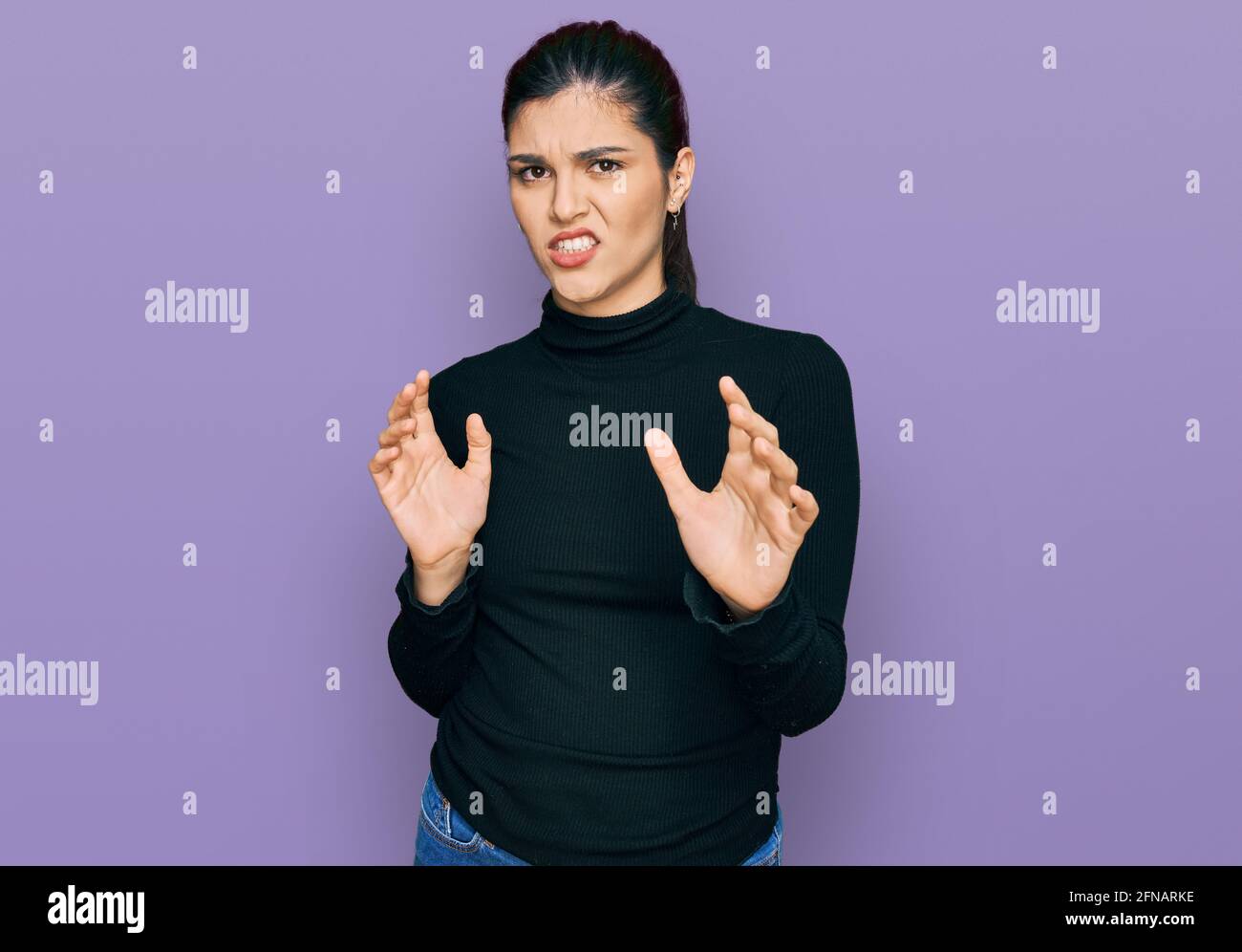 Young hispanic woman wearing casual clothes disgusted expression ...
