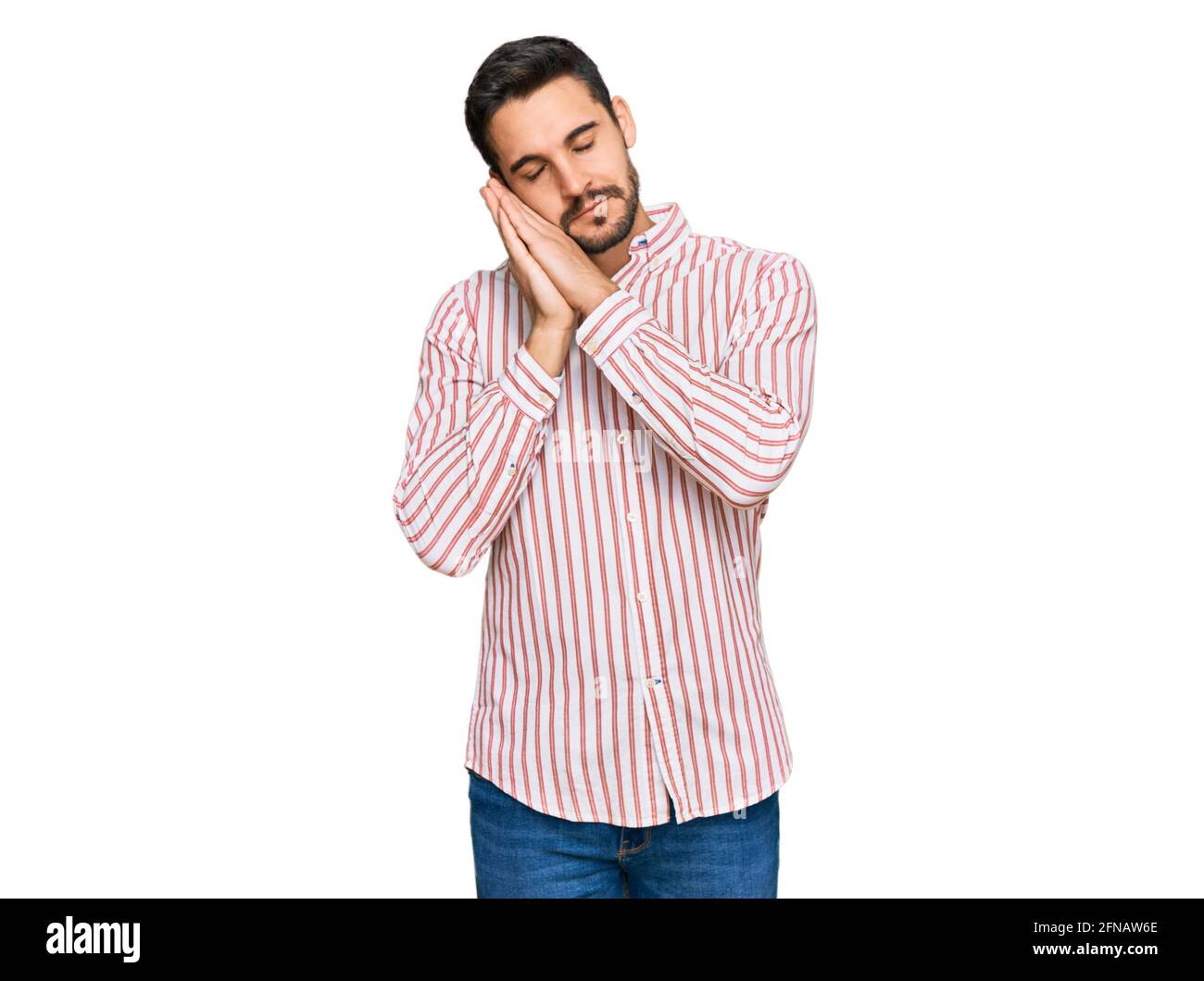 Young hispanic man wearing business shirt sleeping tired dreaming and ...