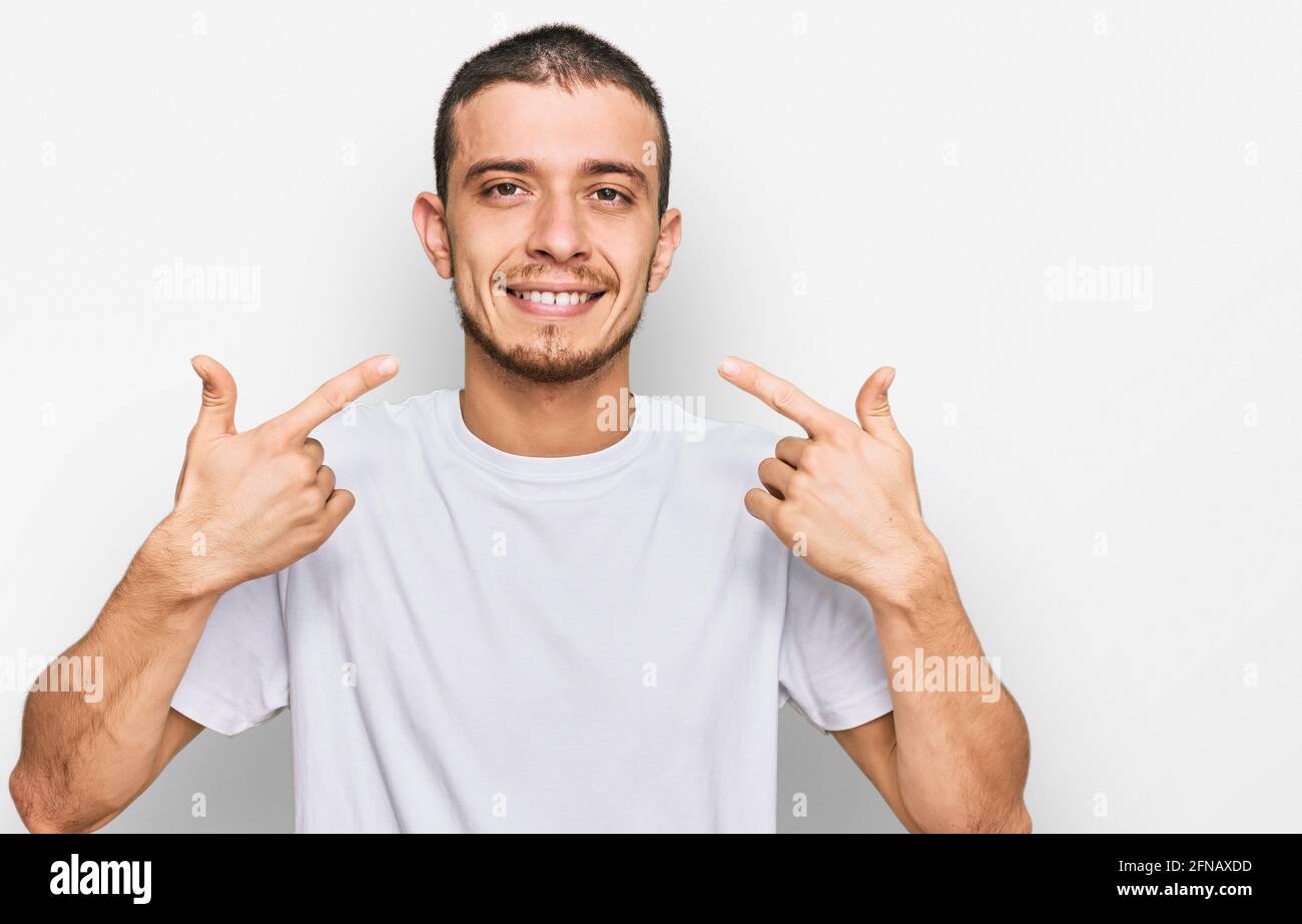 Hispanic young man wearing casual white t shirt smiling cheerful ...
