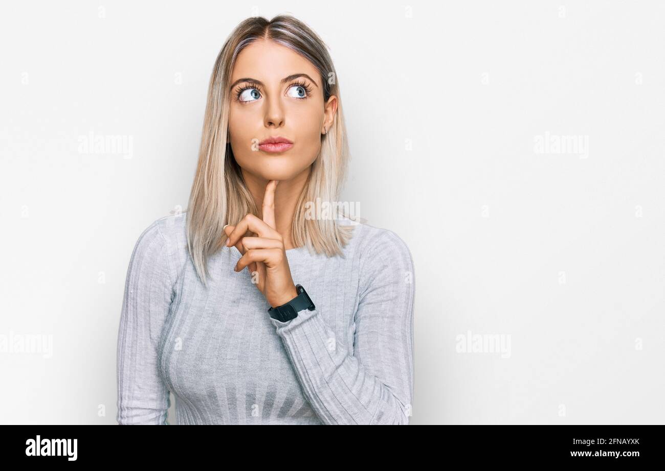 Woman eyes up finger on chin hi-res stock photography and images - Alamy