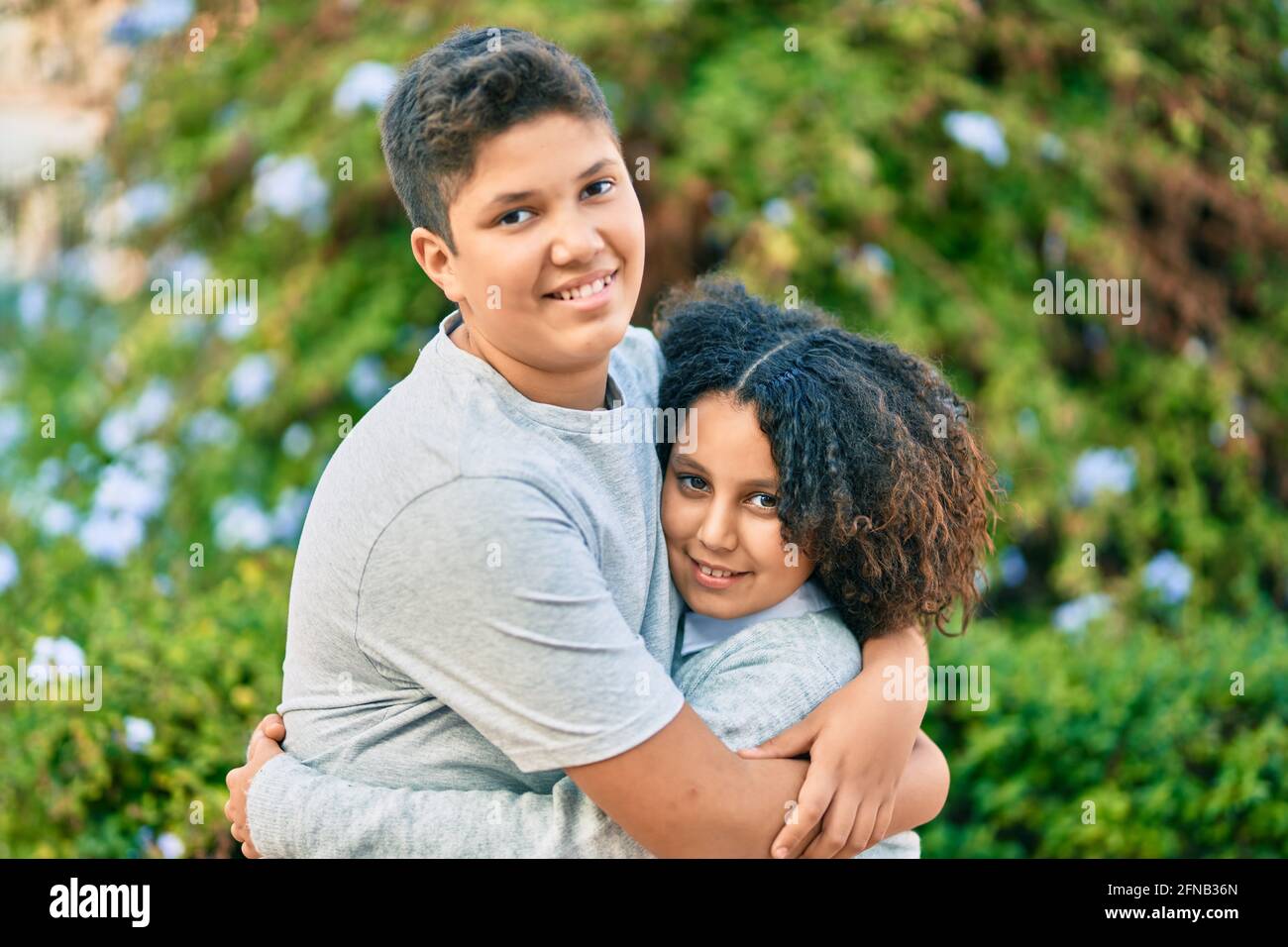 Adorable latin brother and sister hugging at the park Stock Photo - Alamy