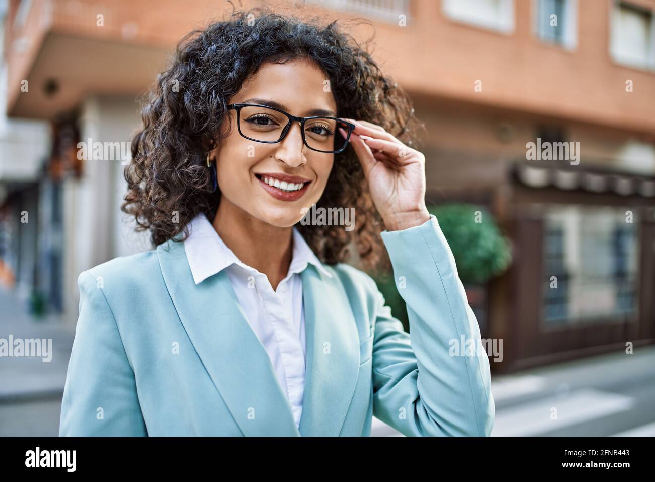 Young hispanic business woman wearing professional look smiling ...