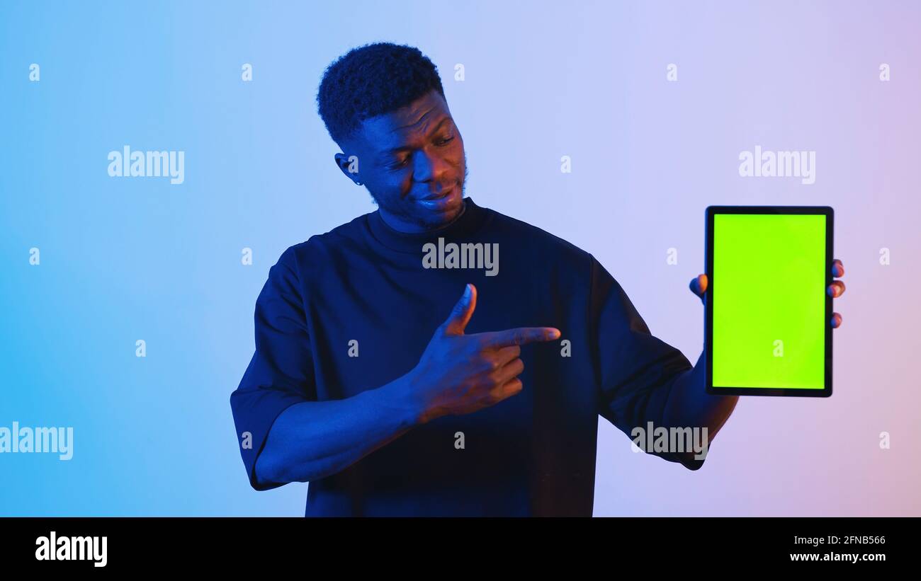 African american black man holding a digital tablet with a green screen ...