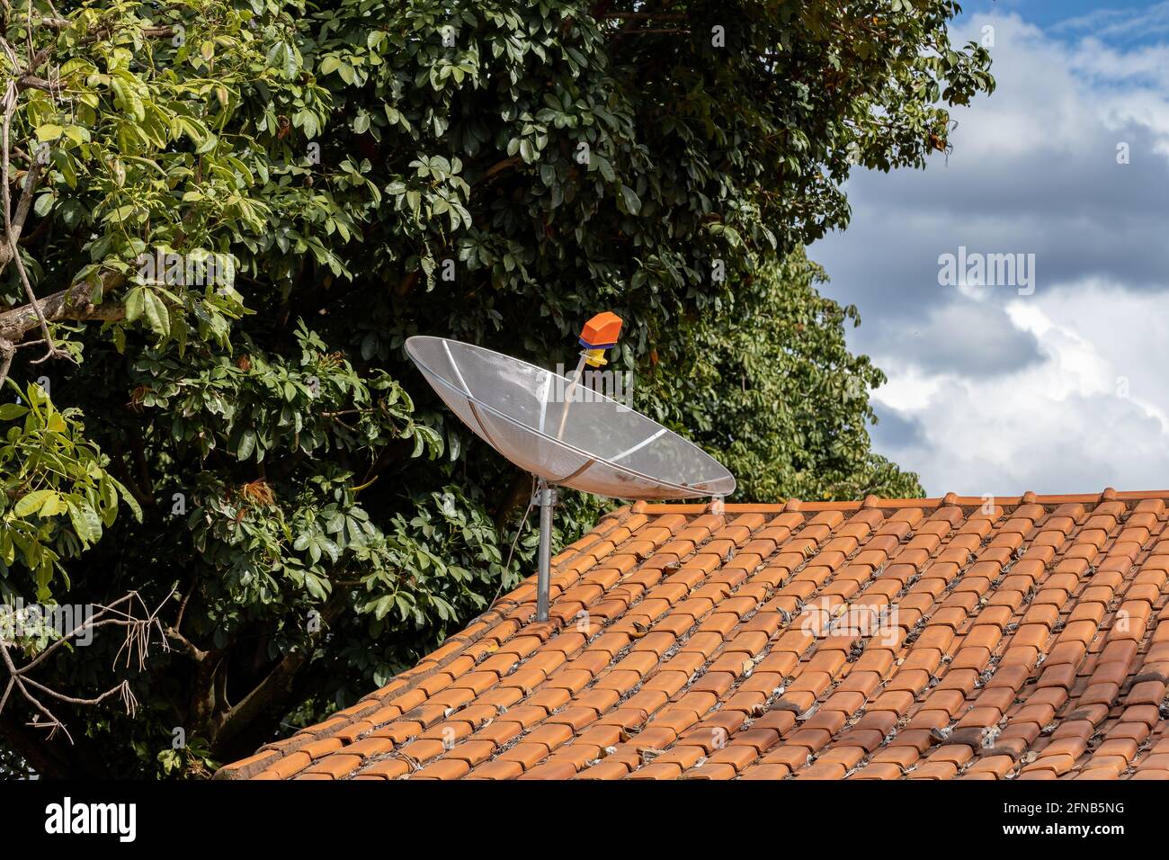 satellite dish for analog television signal installed on roof Stock