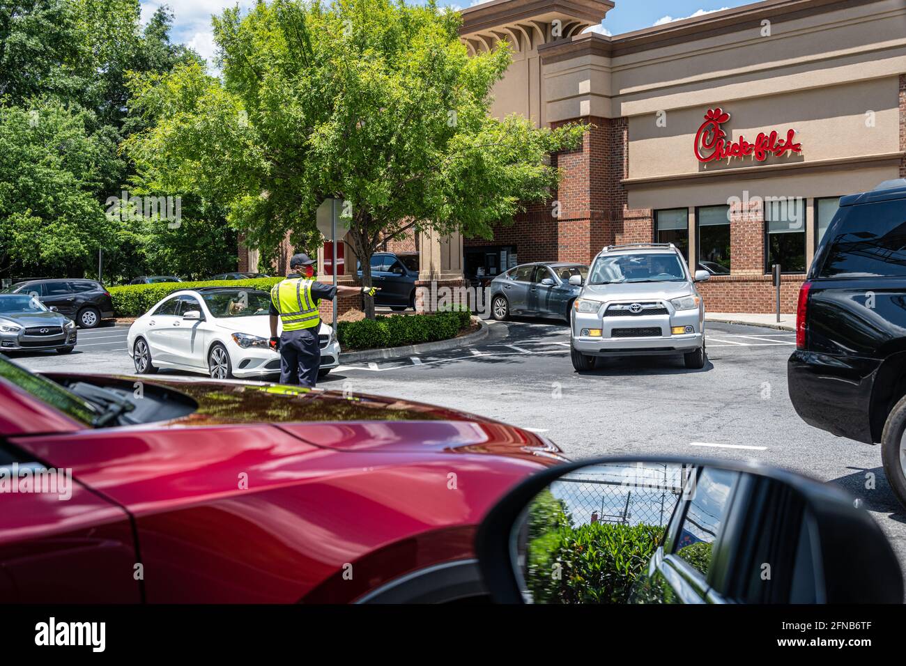 Directing customer traffic at a busy Chick-fil-A restaurant on Piedmont Road in the Buckhead district of Atlanta, Georgia. (USA) Stock Photo