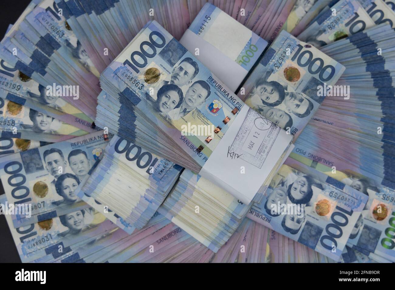 A pile of one thousand Philippines banknotes. Cash of Thousand