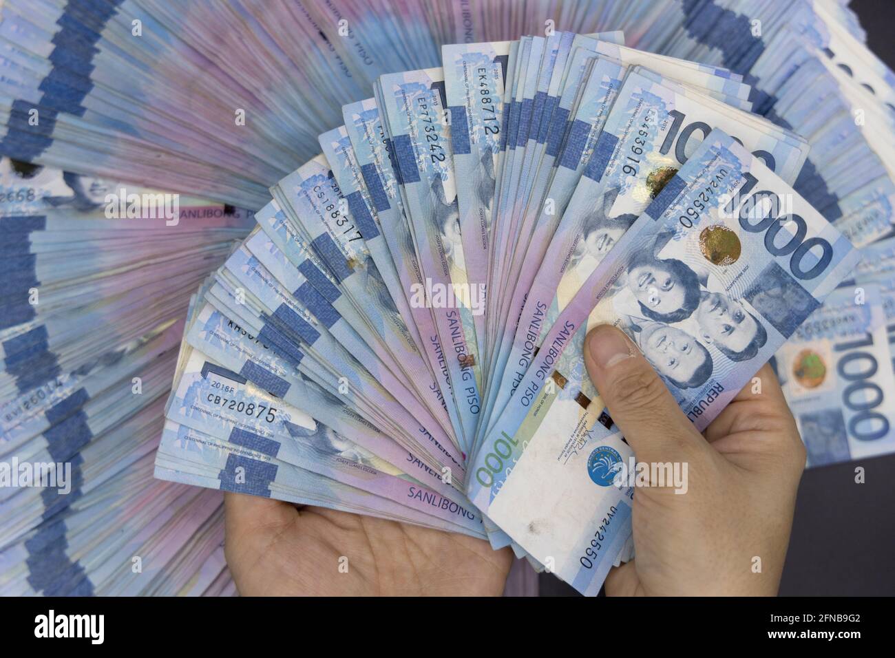 A pile of one thousand Philippines banknotes. Cash of Thousand