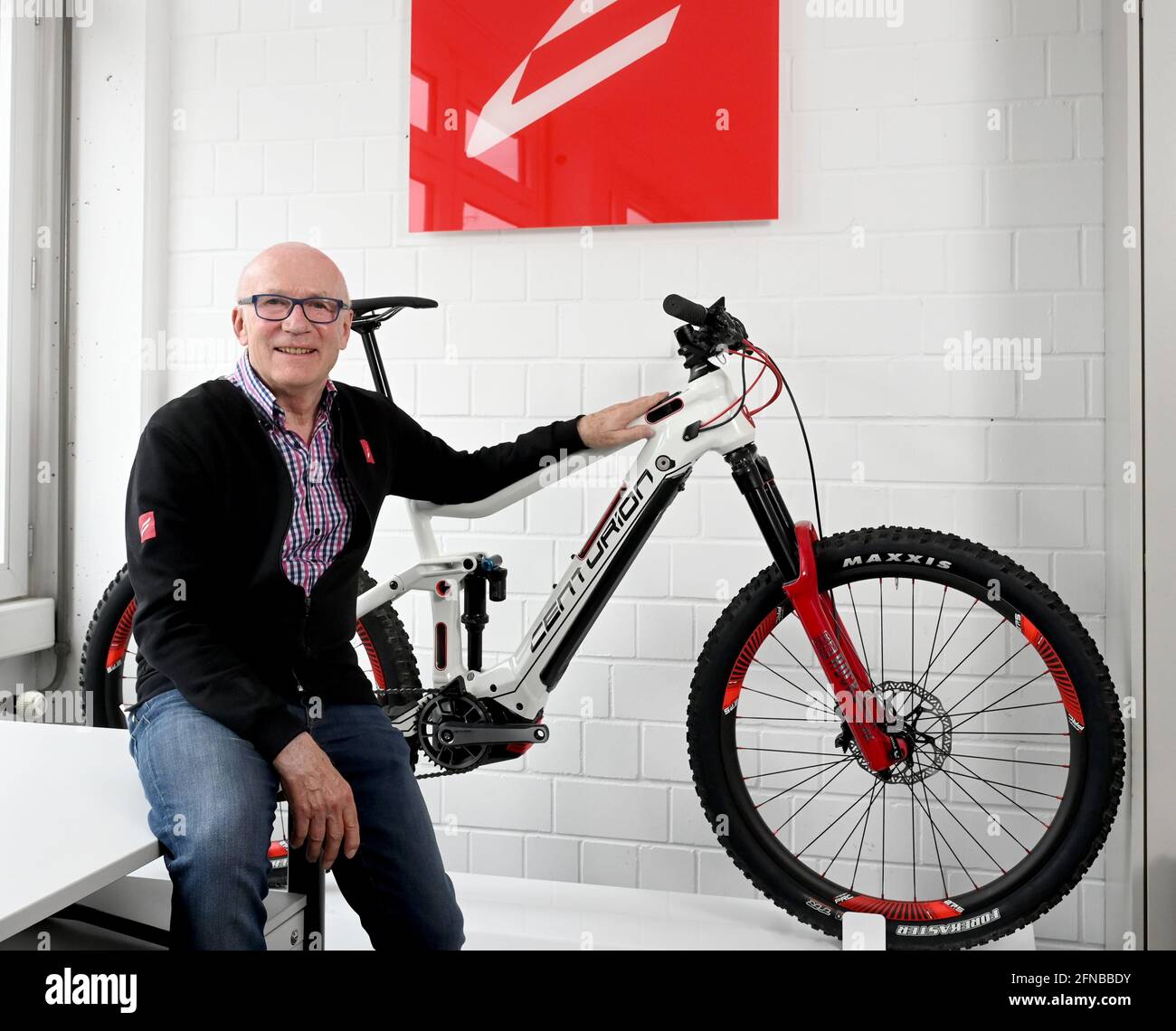 Stuttgart, Germany. 06th May, 2021. Wolfgang Renner, bike pioneer of the  Centurion brand, stands next to an e-mountain bike in his development  department. Due to the current bicycle boom, more bikes are