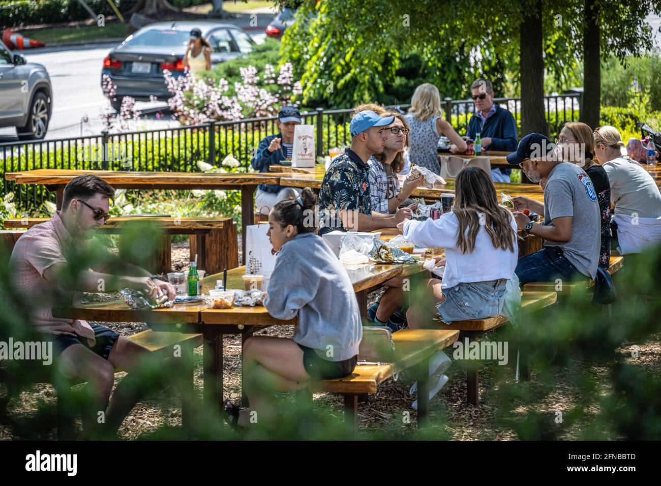 Outdoor dining area with custom hewn wood picnic tables at the Atlanta