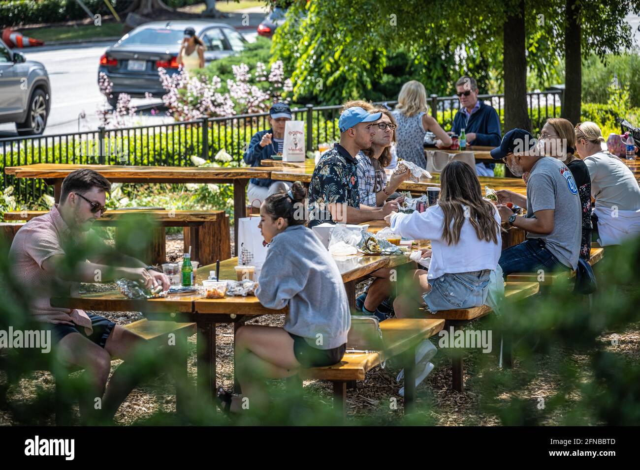 Outdoor dining area with custom hewn wood picnic tables at the Atlanta History Center in the Buckhead District of Atlanta, Georgia. (USA) Stock Photo