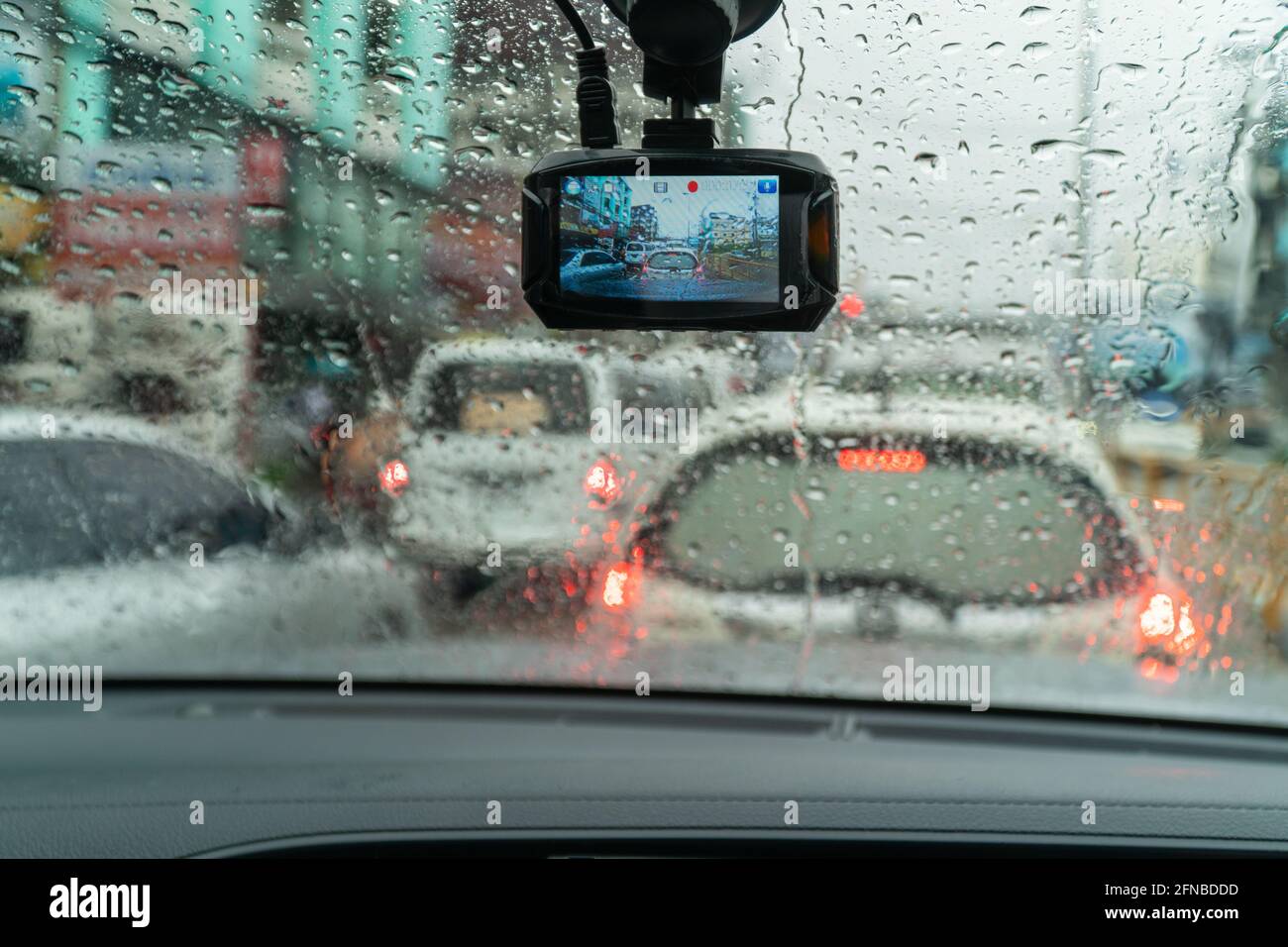 Raindrops on windshield from inside the car in traffic jam Stock Photo