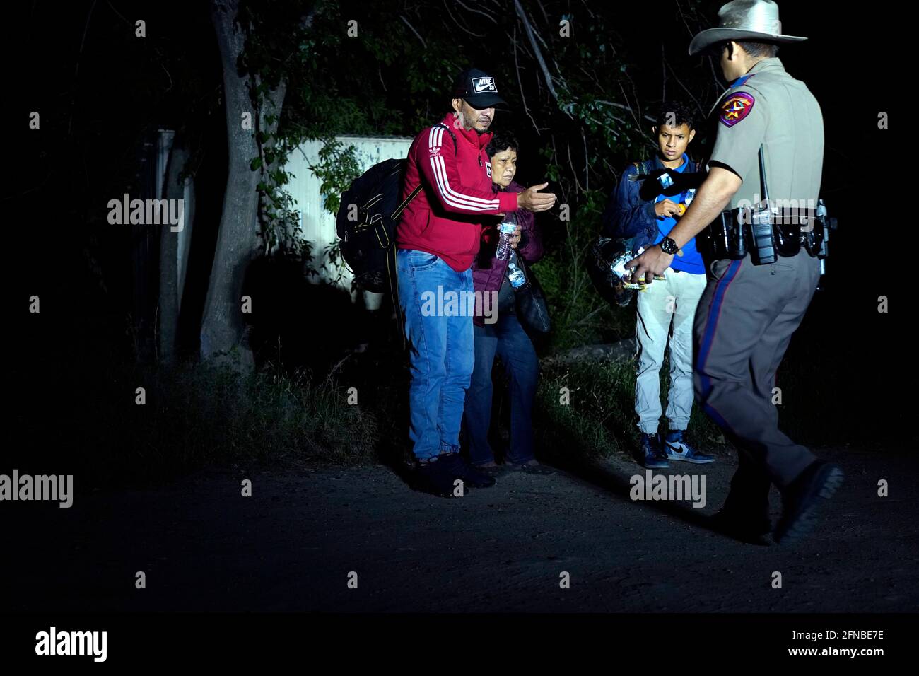 Del Rio, United States. 15th May, 2021. Migrants from Venezuela are detained by Texas Highway Patrol after having crossed the US/Mexico border into the USA.According to unofficial estimates approximately 200,000 migrants have crossed into the United States along the southern border since February 2021. Credit: SOPA Images Limited/Alamy Live News Stock Photo