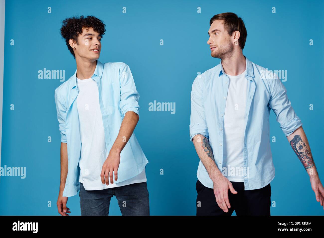 t-shirts on a blue background gesturing ...