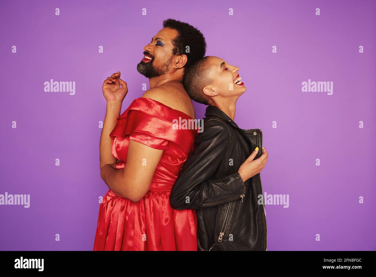 Gender fluid male and female smiling together on purple background. Non