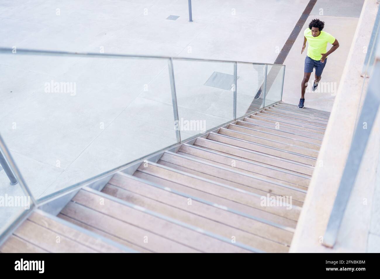 Black man running up stairs hi-res stock photography and images - Alamy