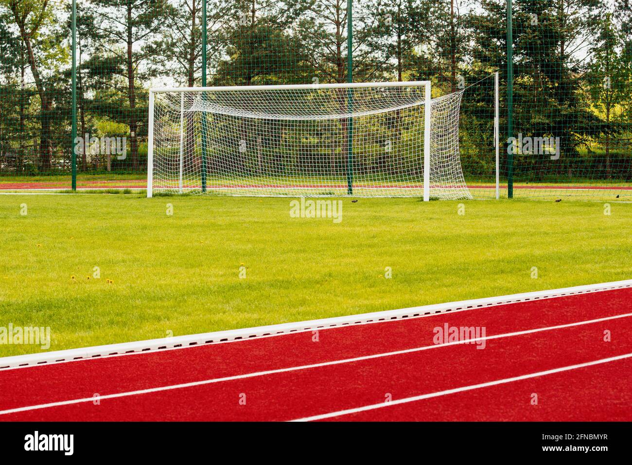 Outdoor athletics treadmill running track with behind soccer gate Stock Photo Alamy