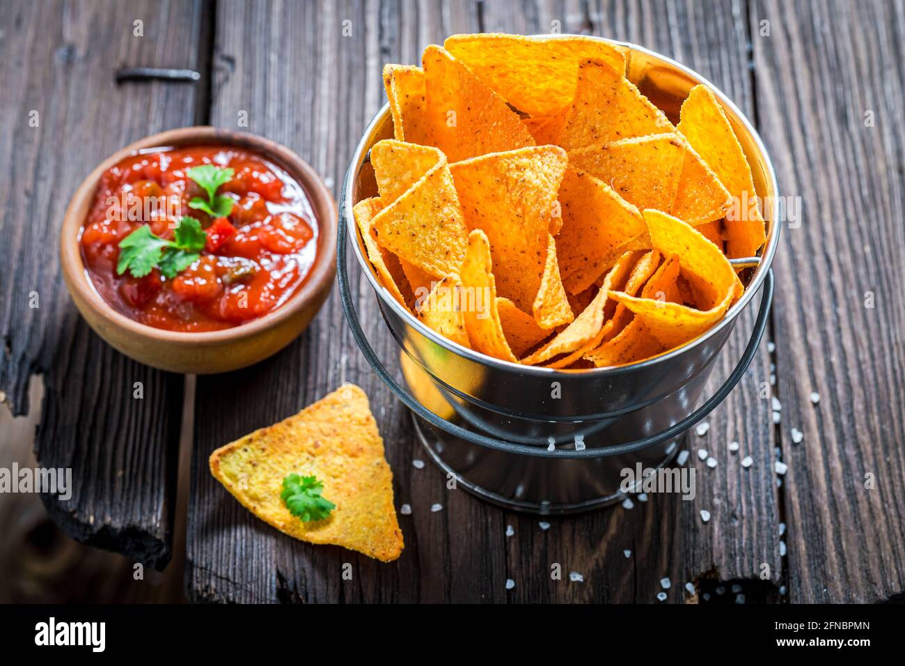 Mexican nachos as a snack for a party. Mexican snack popular in the cinema. Stock Photo